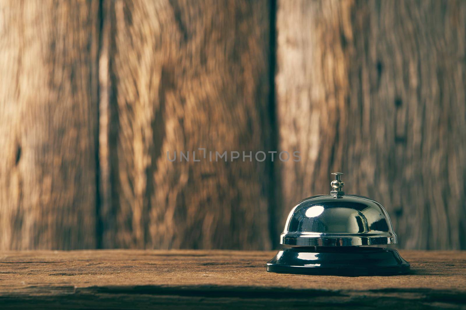 Bell on wood for service with wooden background