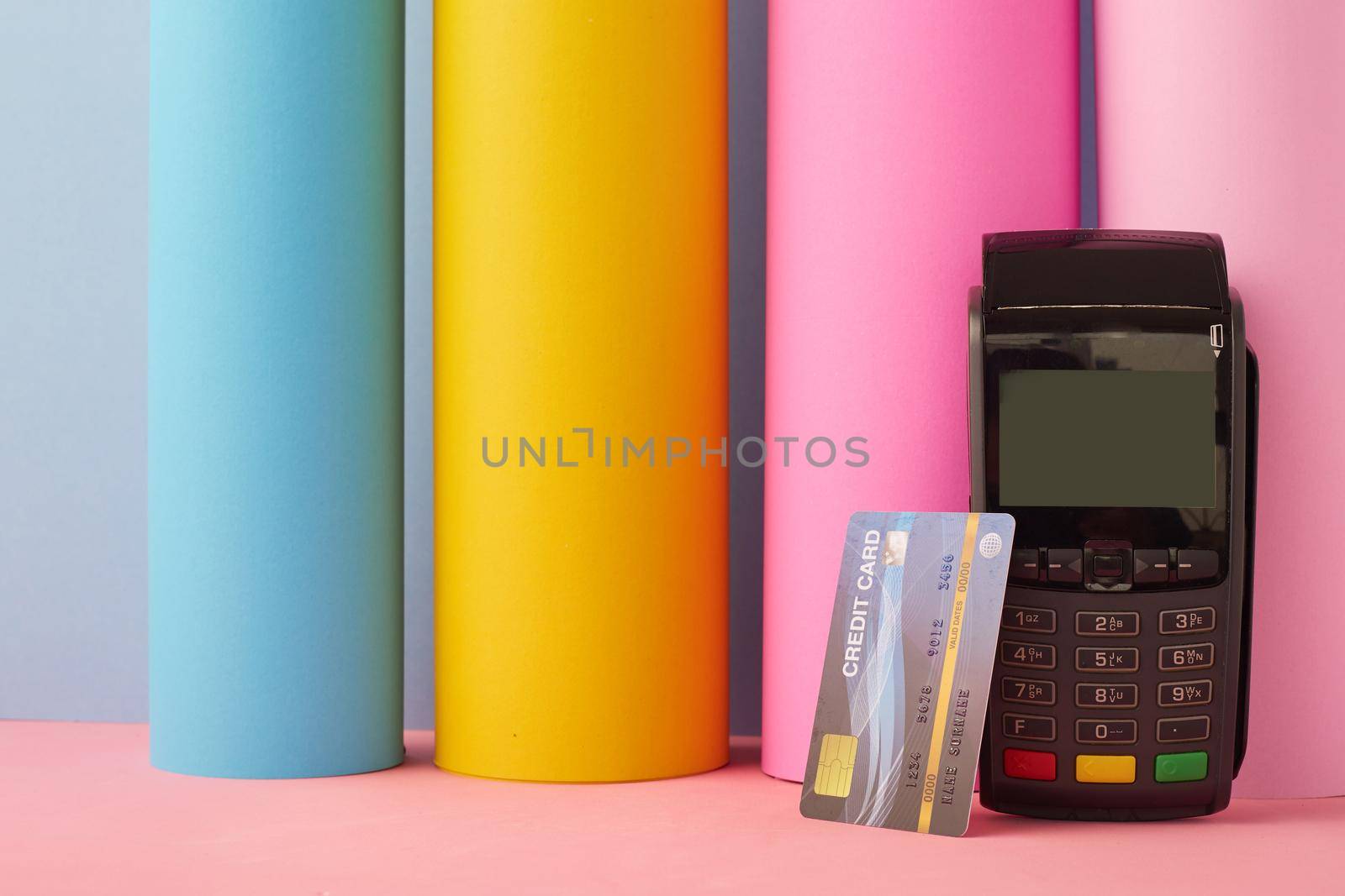 Credit card with credit machine on Colorful background