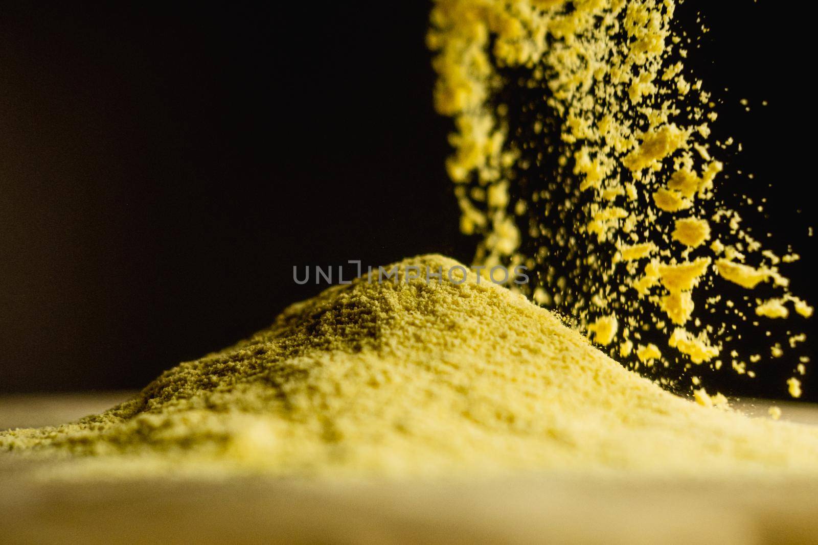 Corn starch, ,cooking ingredient in movement, black background. High quality photo