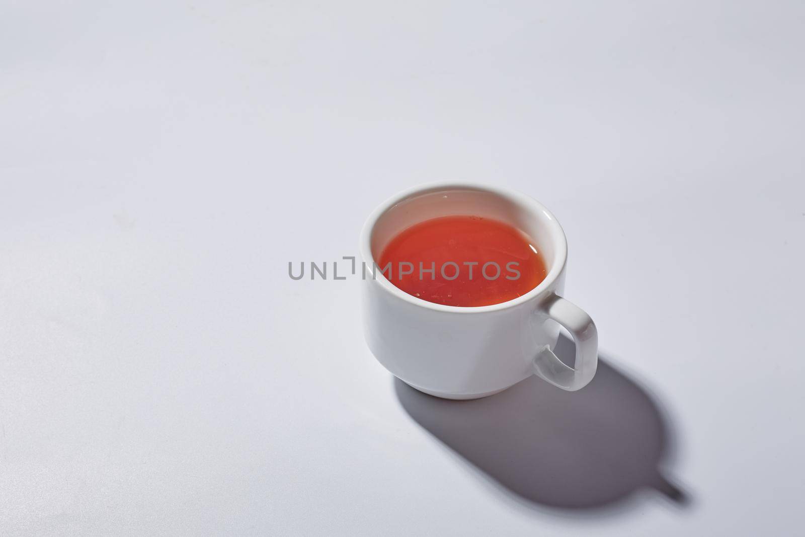 Tea cup with hard light on white background