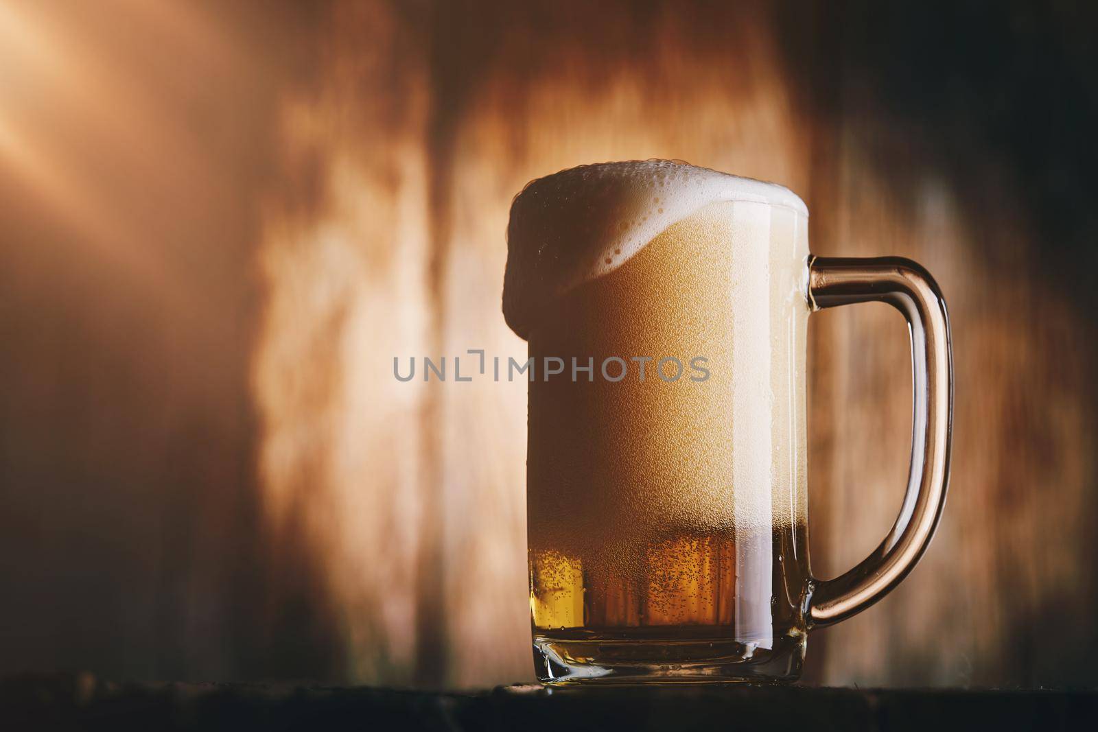 Beer in mug on wooden table by Wasant