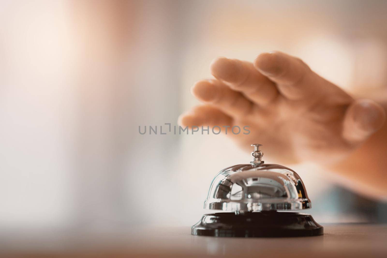 Bell on counter for service with hand. Ring the bell