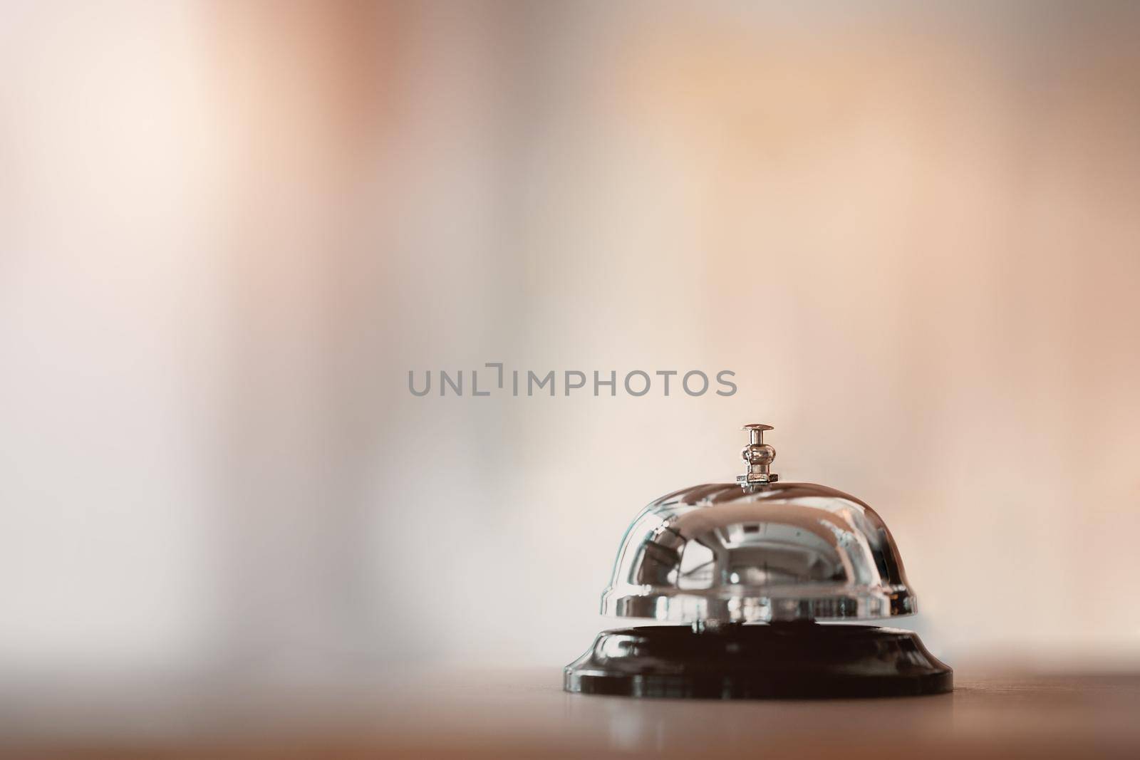 Bell on counter for service with hand. Ring the bell