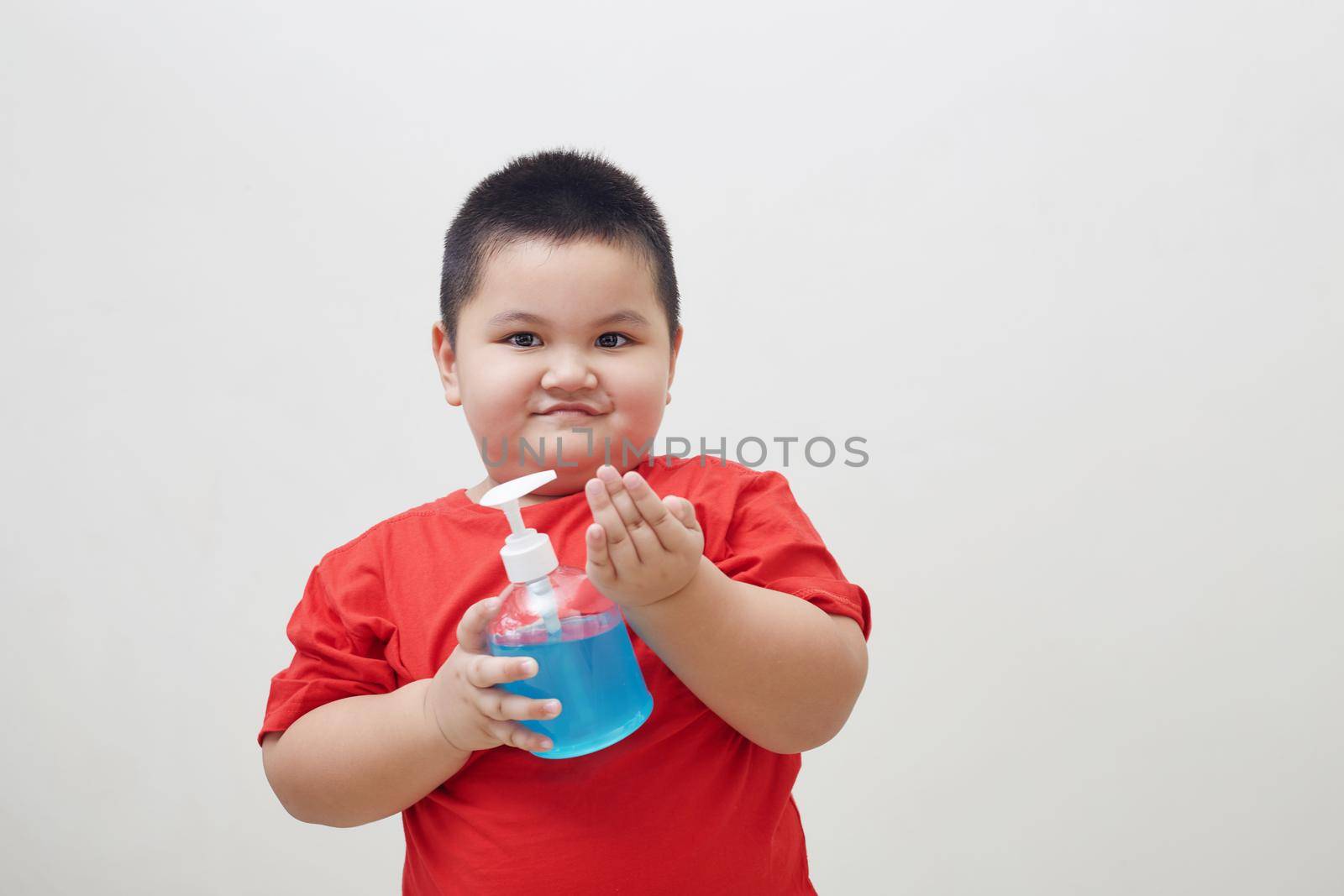 Asia Boy holding bottle with antiseptic cleaning gel. Prevent the virus and bacterias