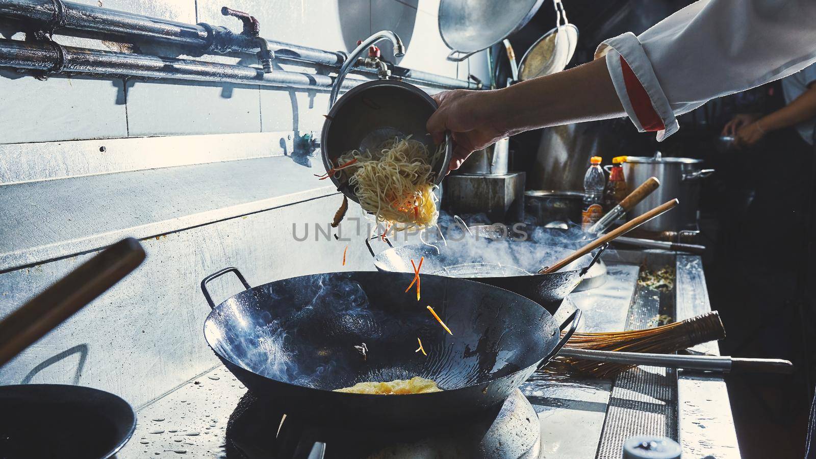 Chef stir fry cooking in kitchen