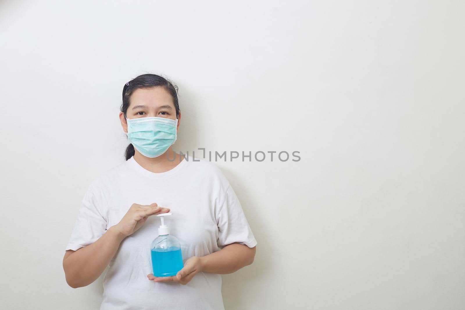 Woman holding bottle alcohol gel. Prevent the virus and bacterias