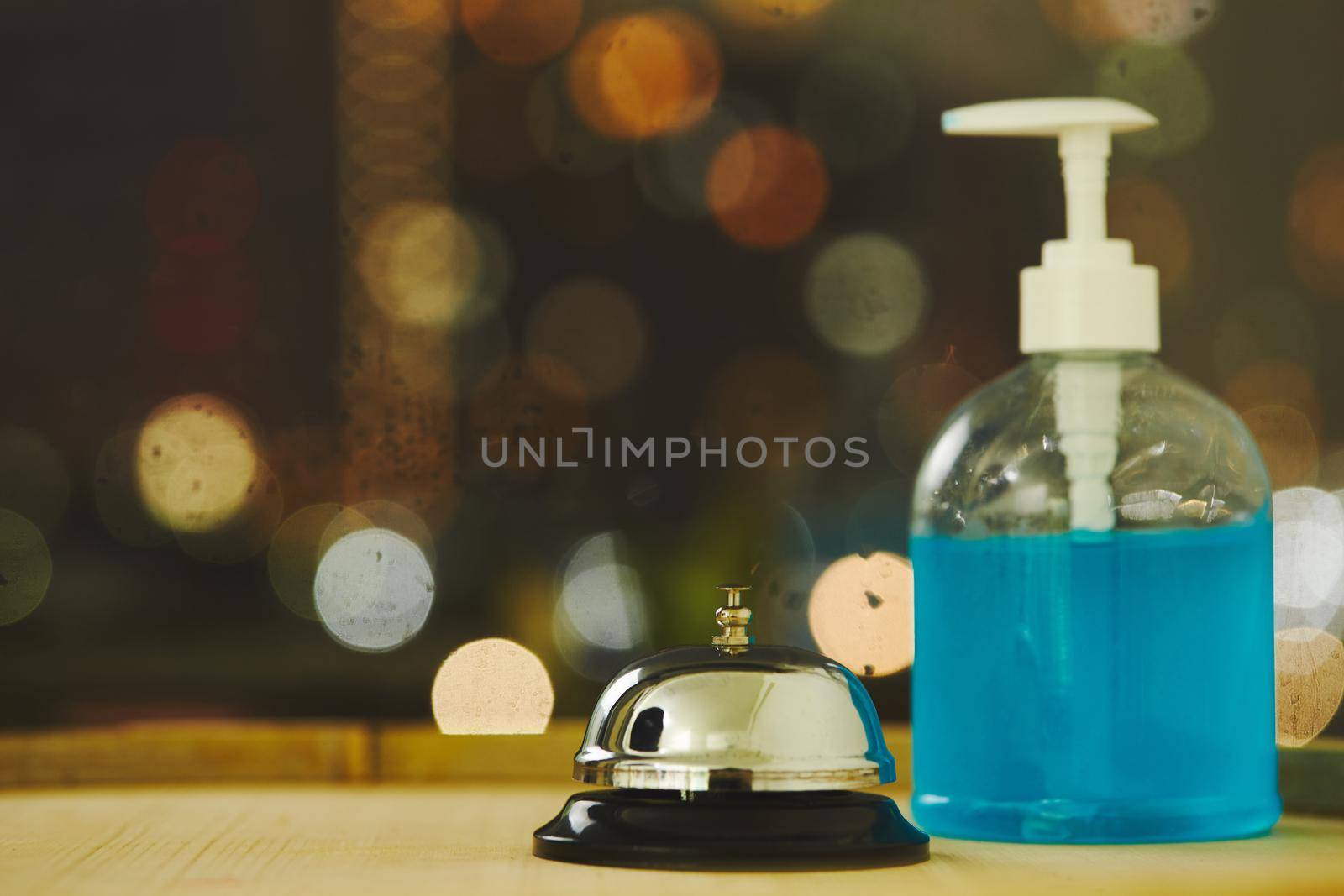 Bell with alcohol gell on counter for service with blurred background