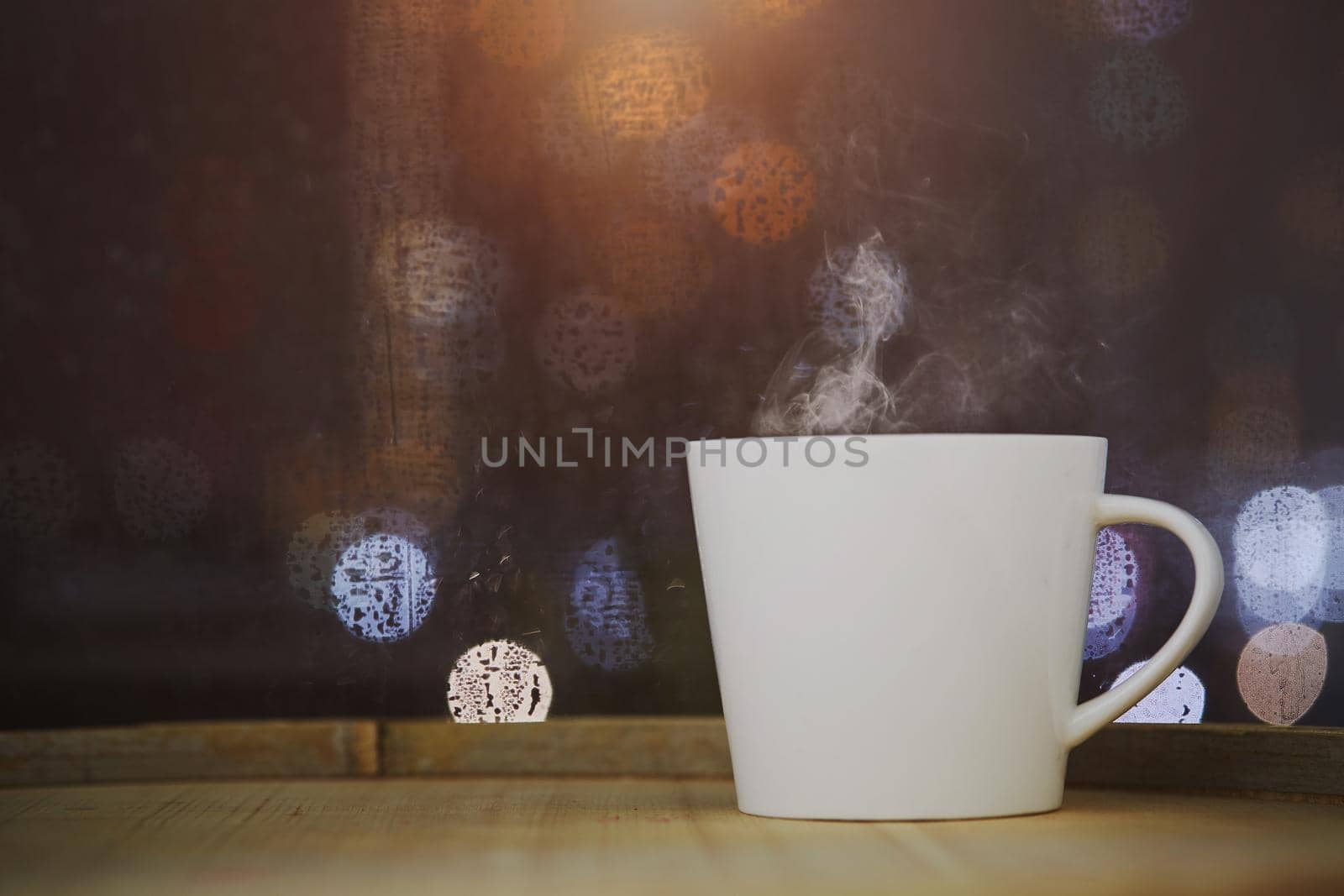 Cup of coffee on wood with bokeh background