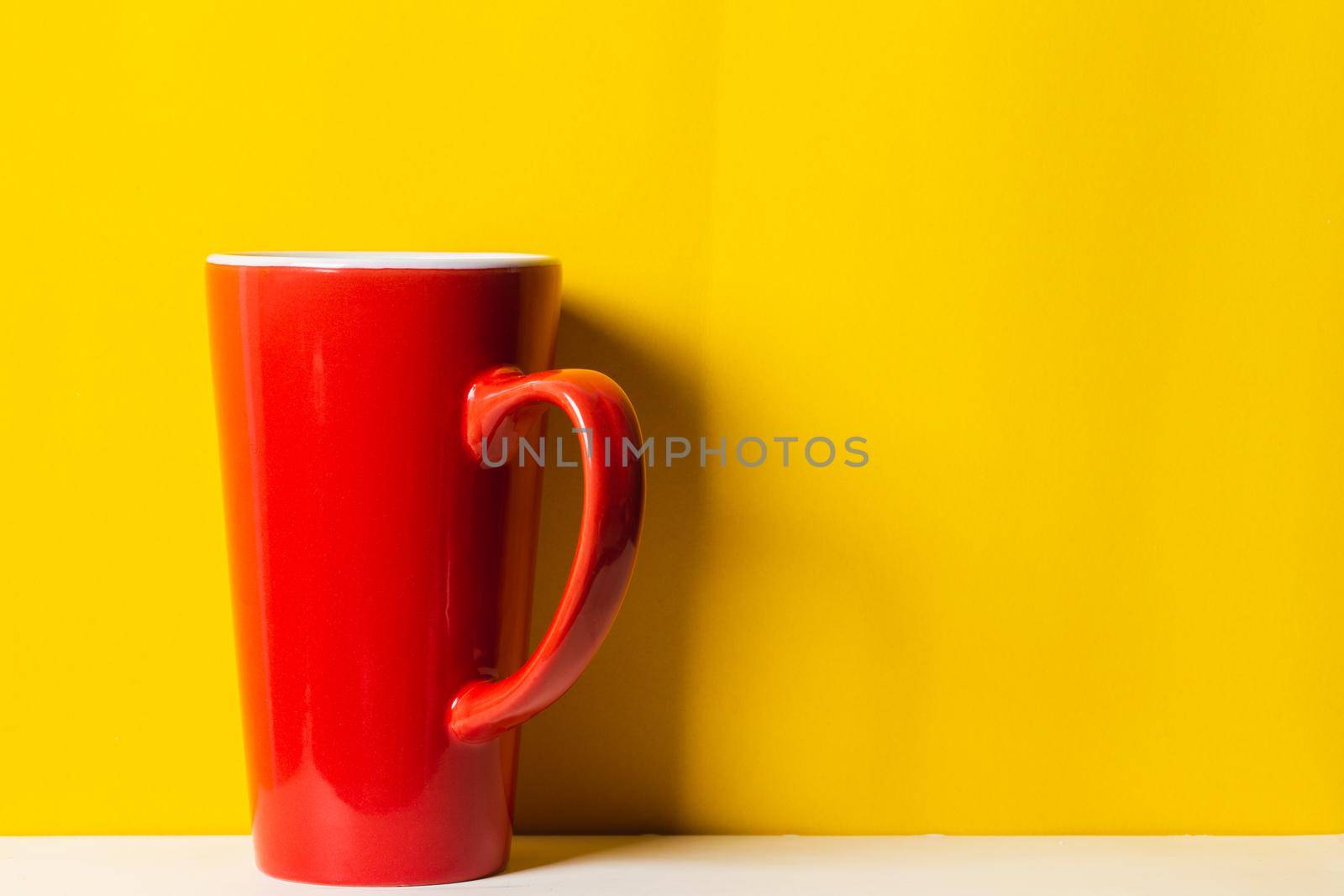 Red cup on yellow background