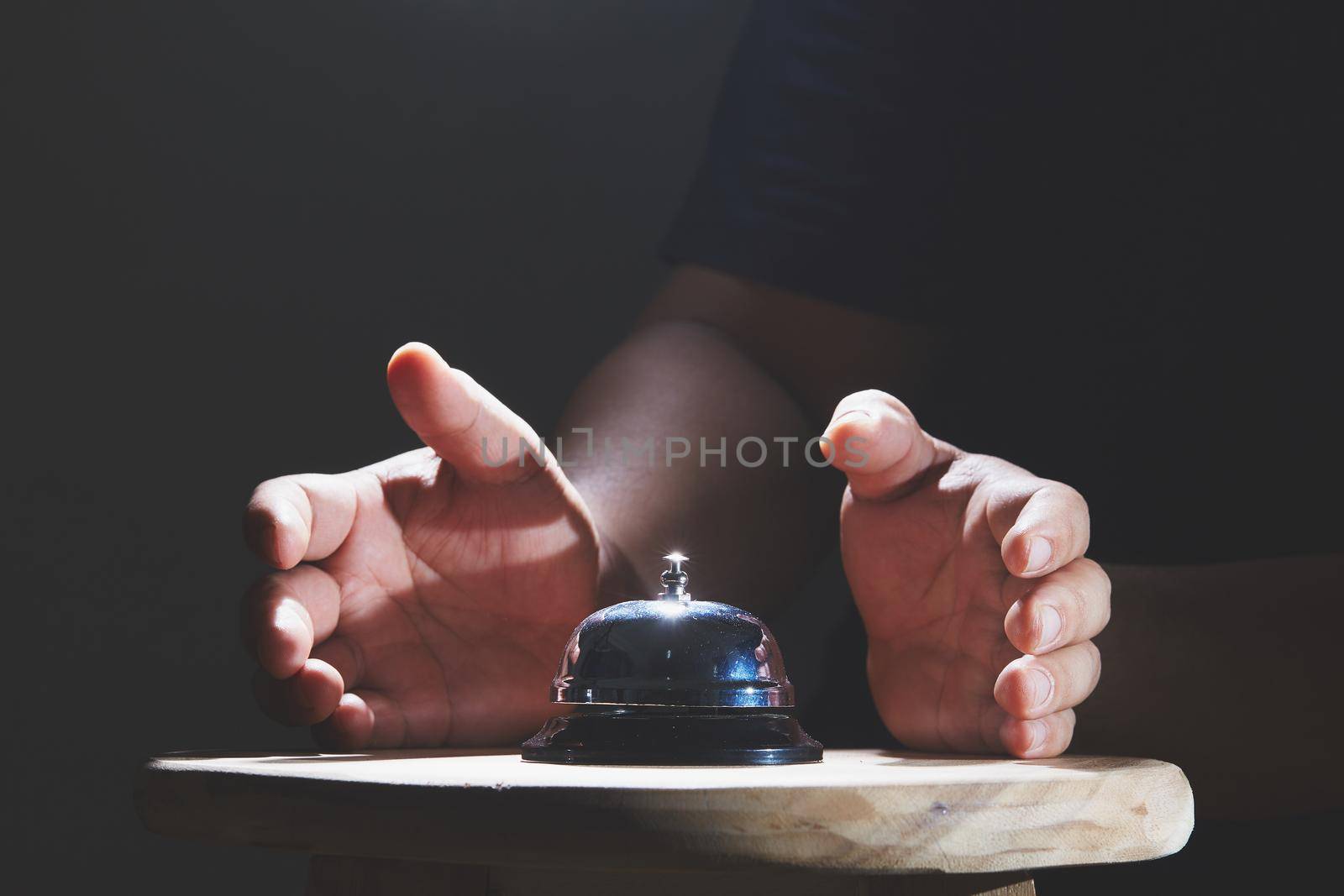 Bell on counter for service with hand background