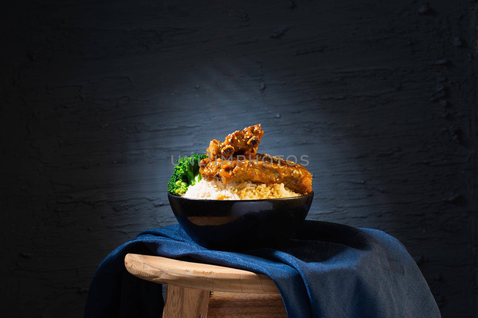 Still life with Baked Pork Ribs Rice on dark background