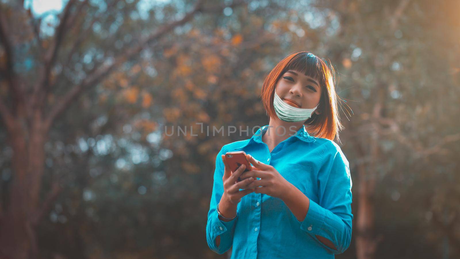 Communication of modern society After the virus outbreak. woman wearing a mask on park, new normal of life