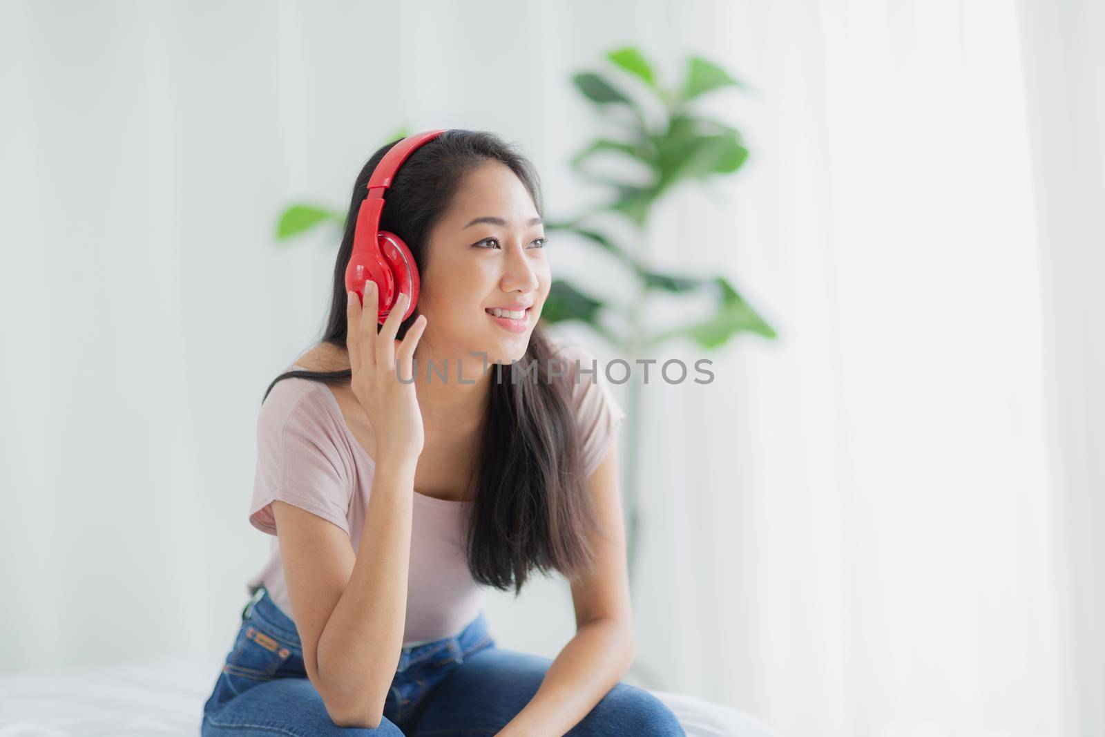 Beautiful women smile happily and relax while listening to music with headphones.