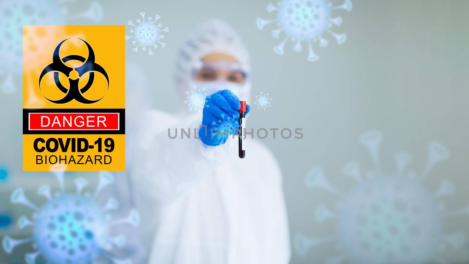 Scientists in the Biohazard protective suit are analyzing the blood sample of Covid-19 in the test tube To find a vaccine, coronavirus covid 19 vaccine research