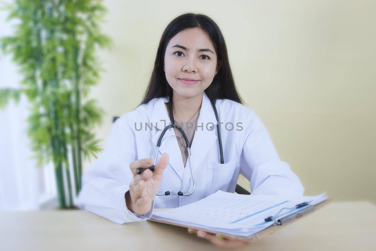 Woman is psychologist wearing white coat with stethoscope looking at camera, doctor make video conference interact through internet talk with patient provide help online counseling and therapy concept