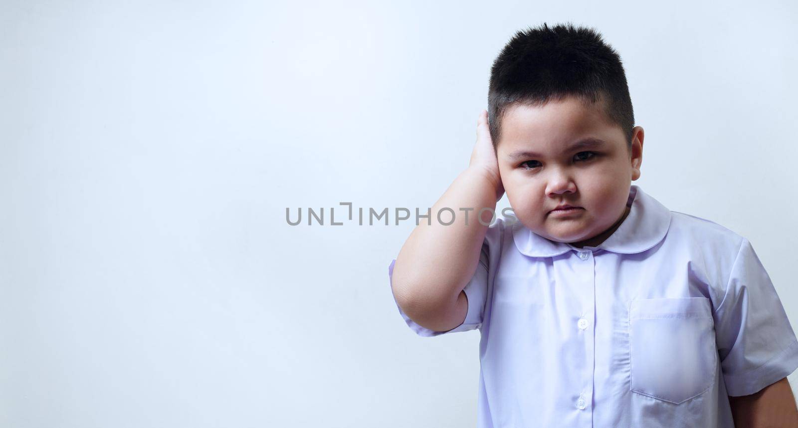 Boy in school uniform crying to school the first day. Children don't want to go to school.