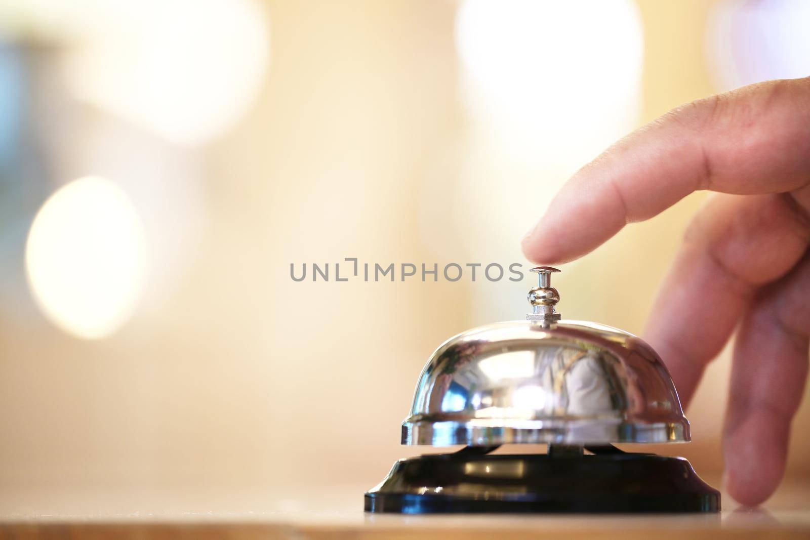 Bell on counter for service with finger customer for call on blurred background, Service concept