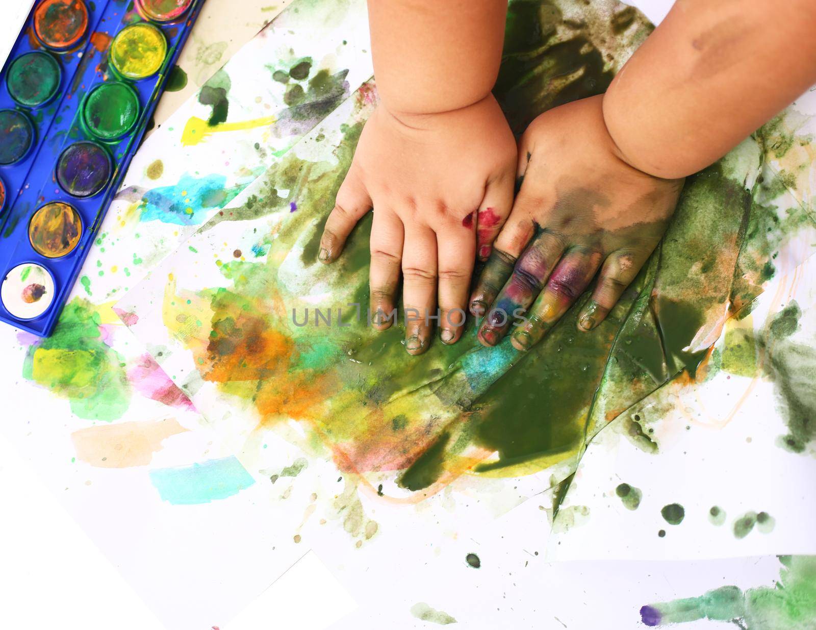 Children painting ink on paper by Wasant