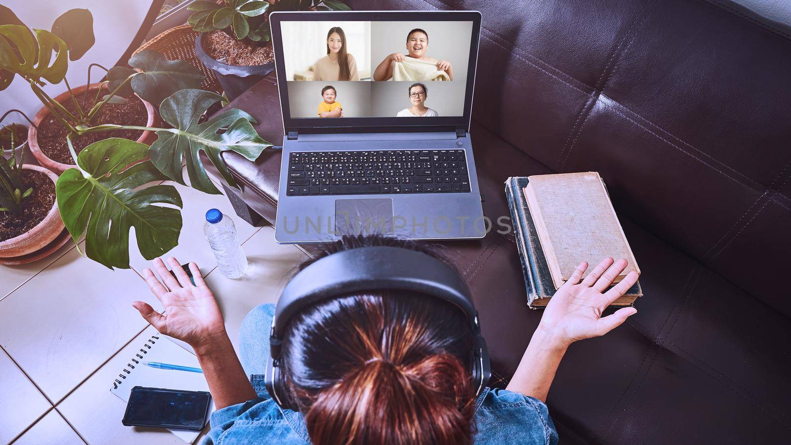 Family making video conference on laptop with social distancing