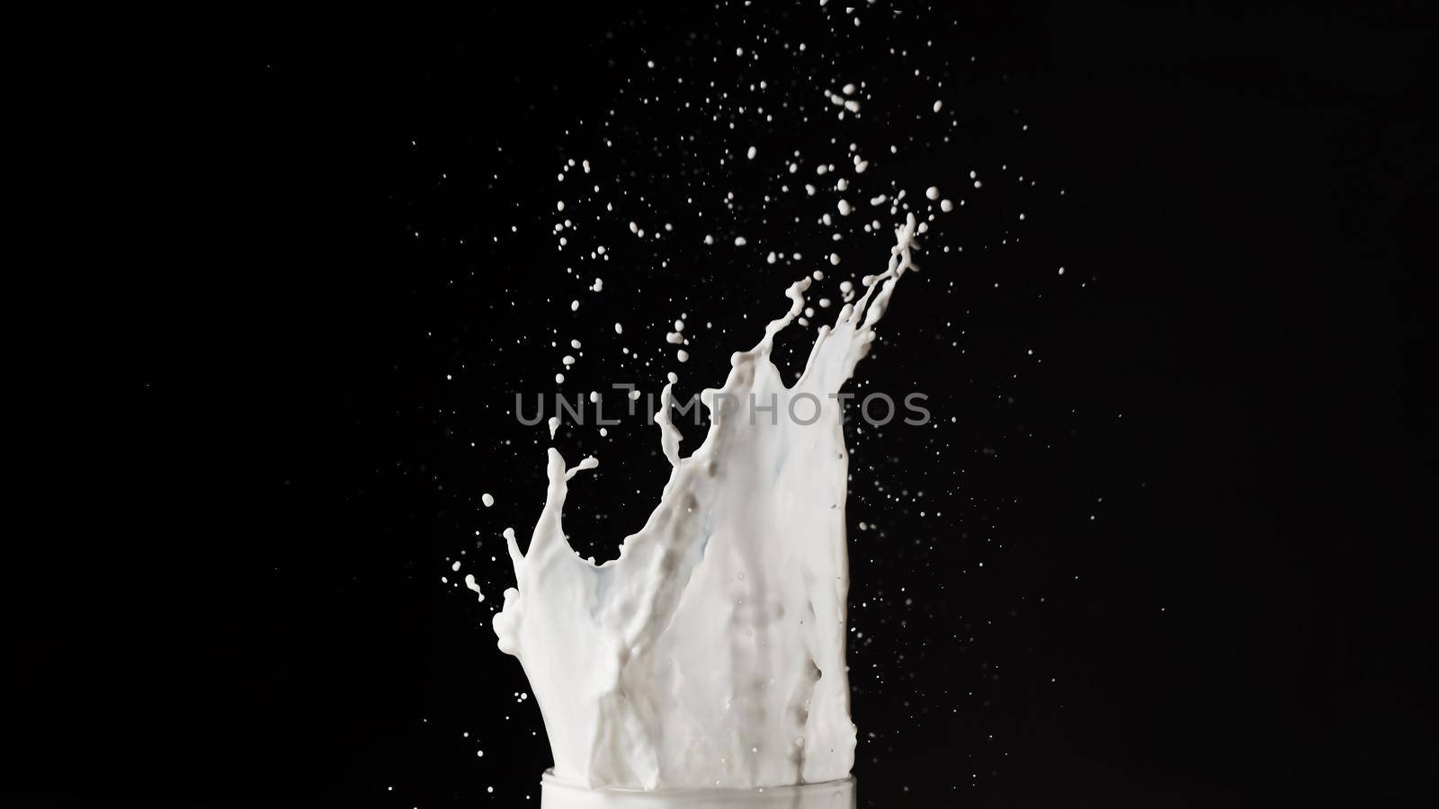 Milk splash on dark background by Wasant