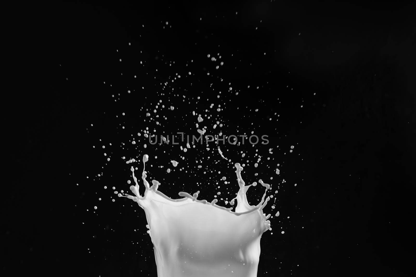 Milk or white liquid splash on dark background