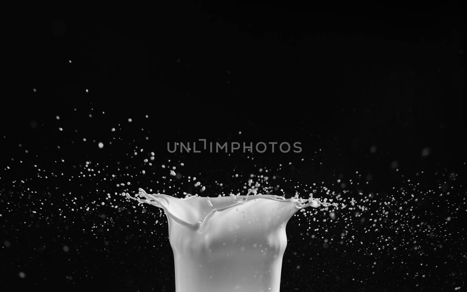 Milk or white liquid splash on dark background