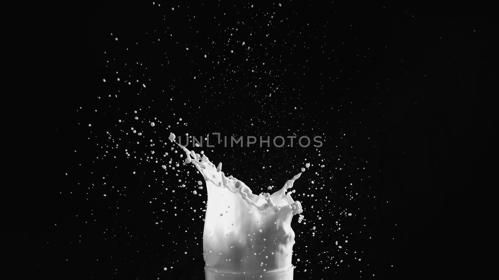 Milk or white liquid splash on dark background