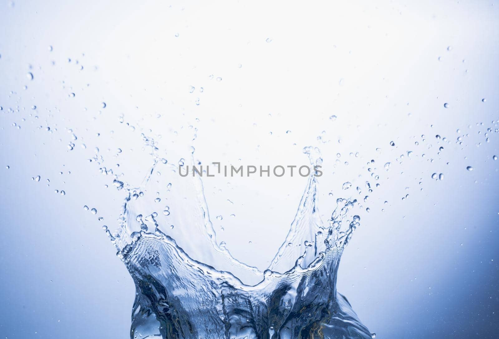 Water splash on blue abstract background