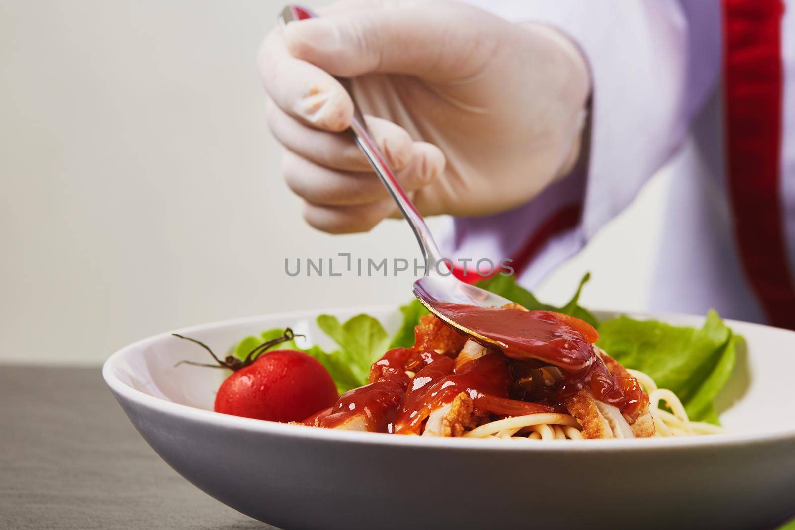 Chef preparing pasta dish by Wasant