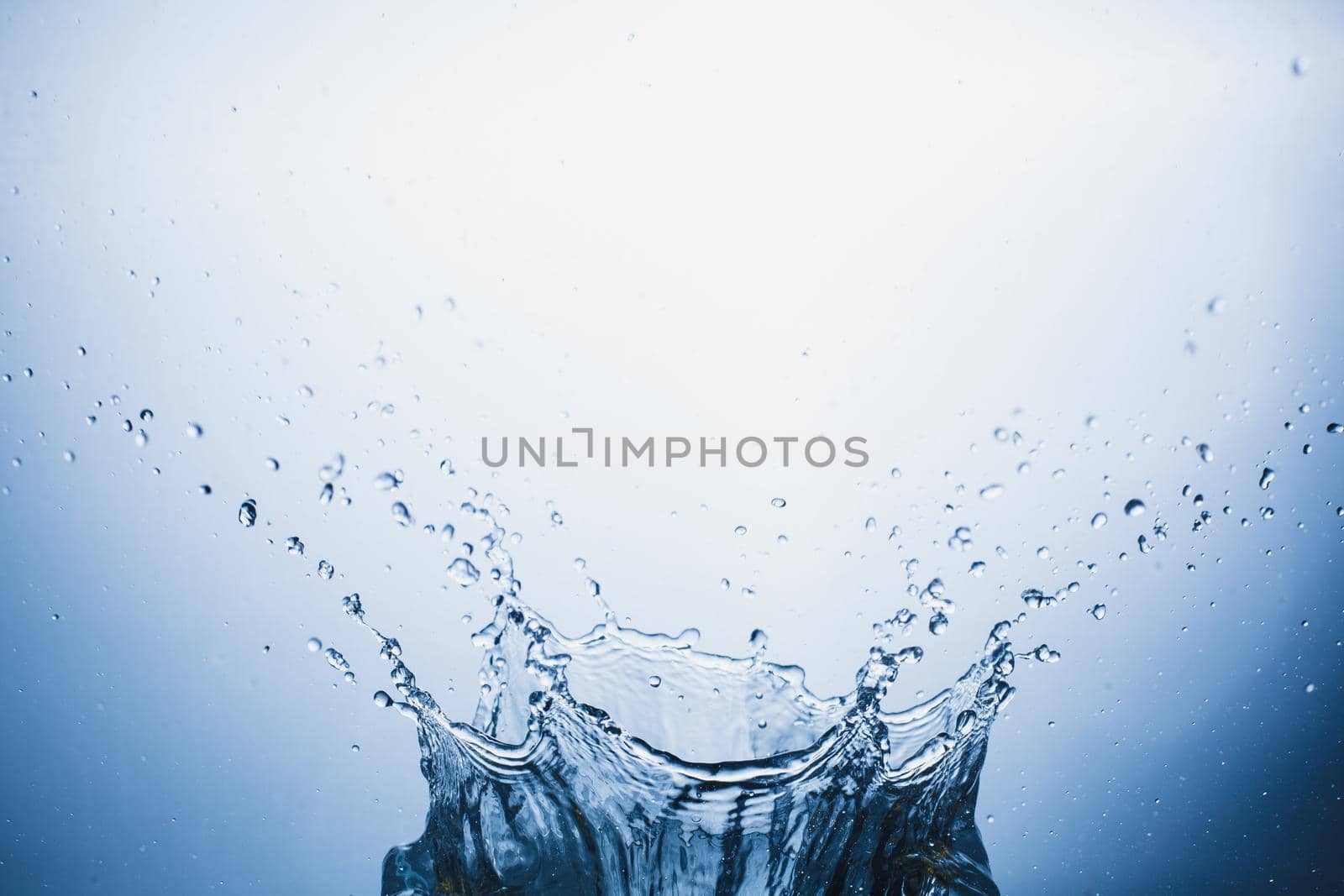 Water splash on blue abstract background