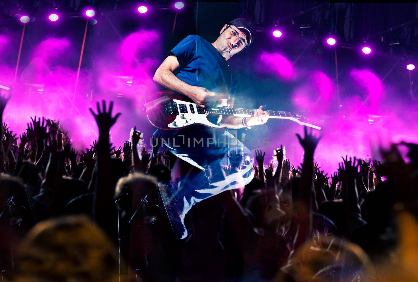 Stage lights.Abstract musical background.Playing guitar and concert concept by carloscastilla