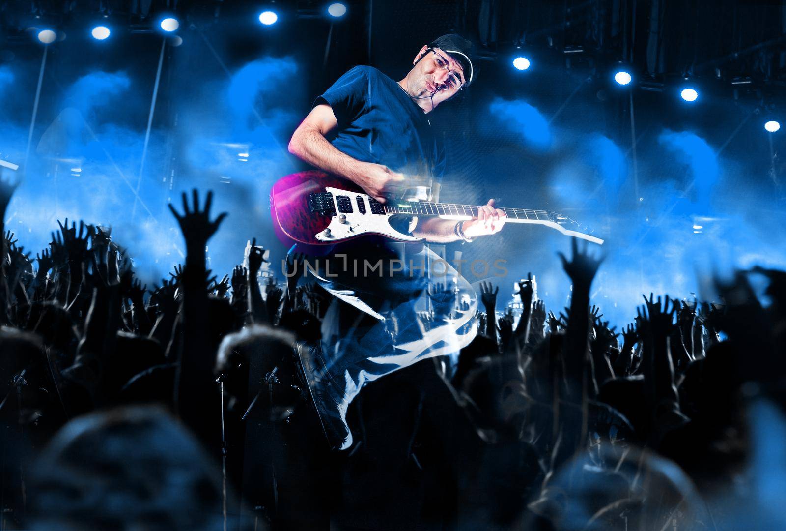 Stage lights.Abstract musical background.Playing guitar and concert concept by carloscastilla