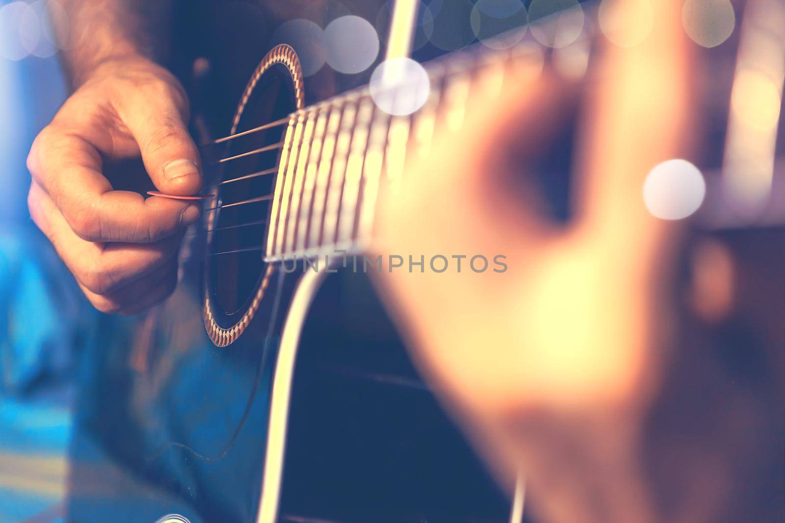 Acoustic guitar and guitarist detail