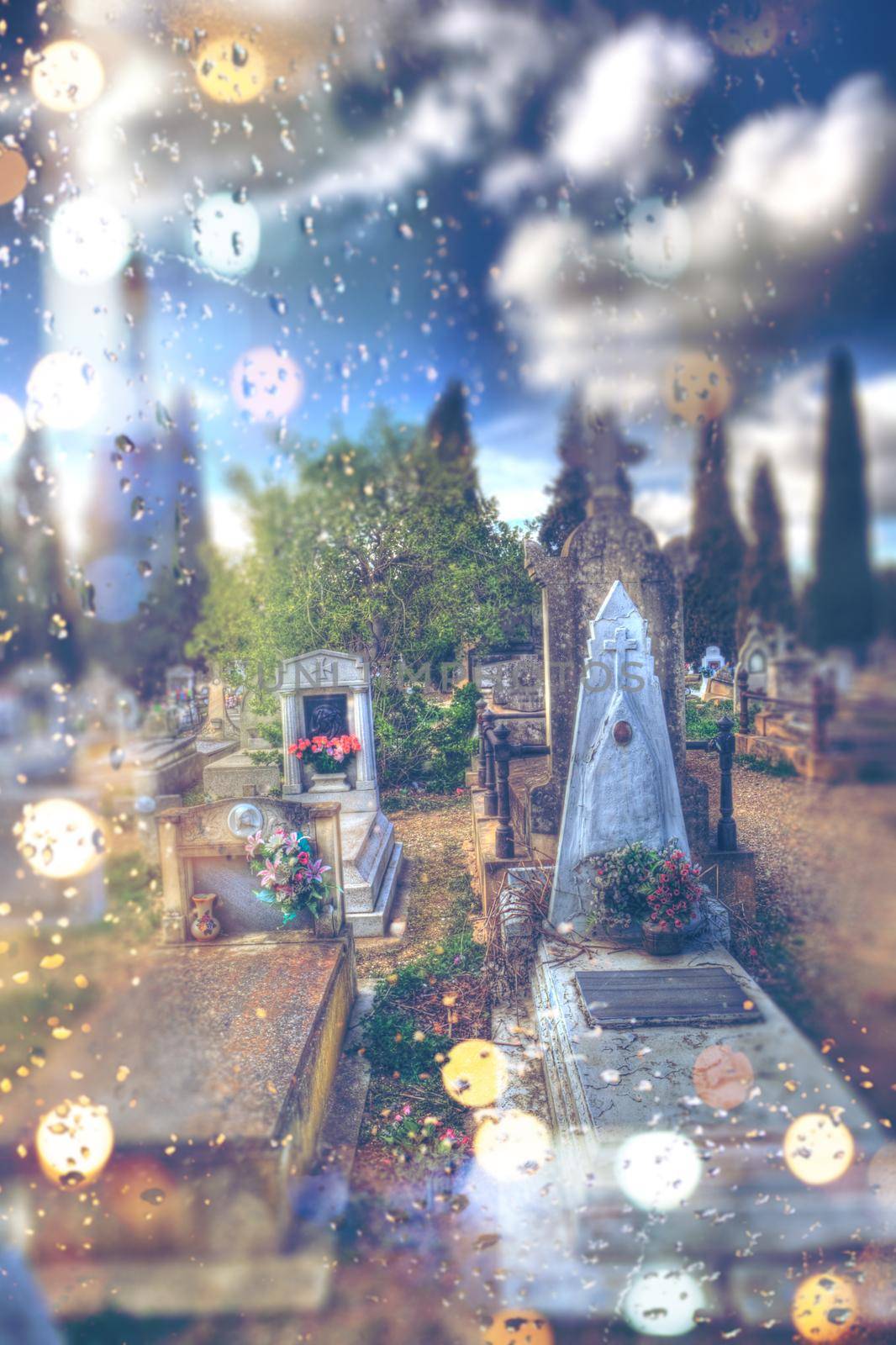 Abstract concept of death and passage of time with grave in the cemetery on rainy day