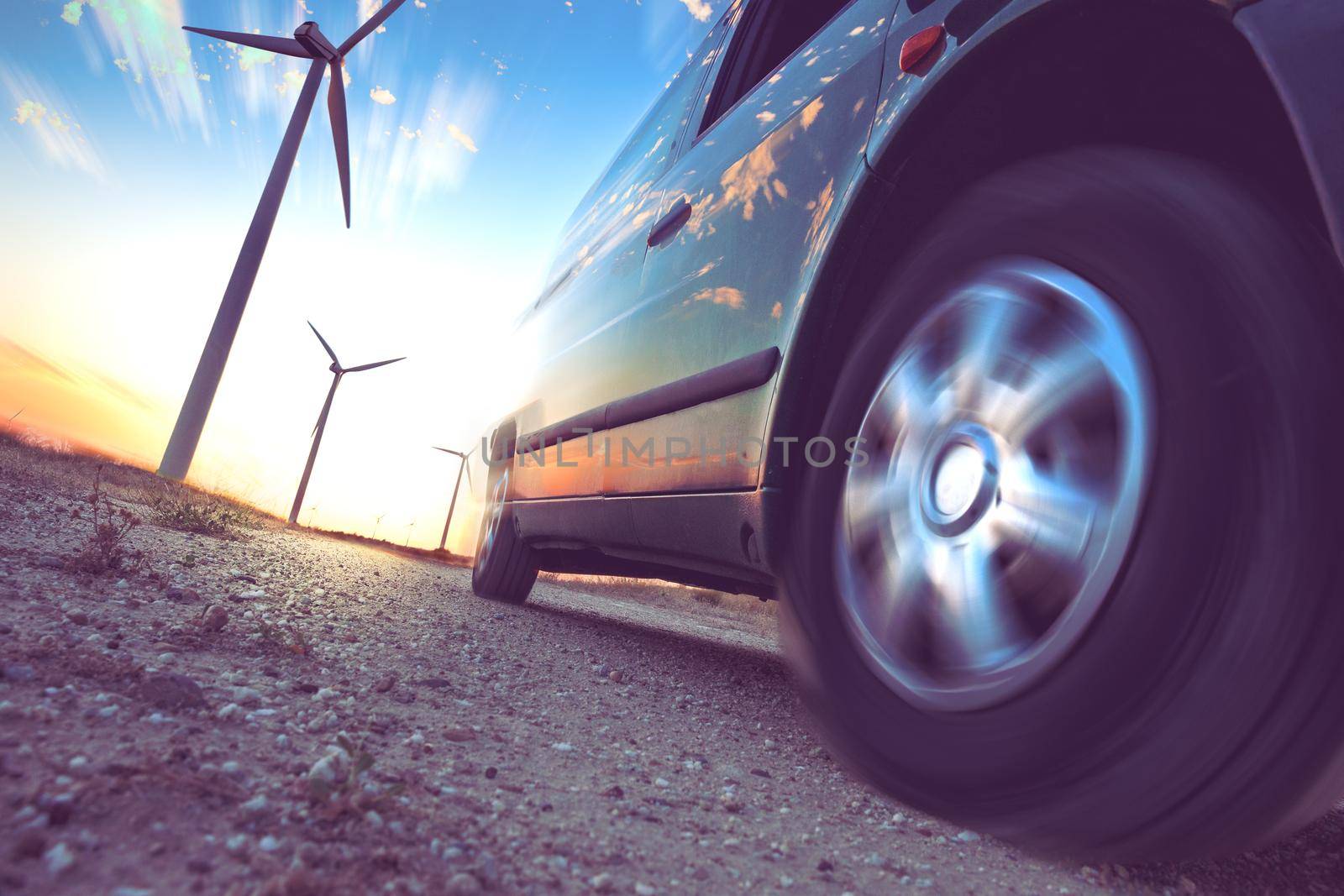 Wind mills and tire car detail.Electricity and ecology