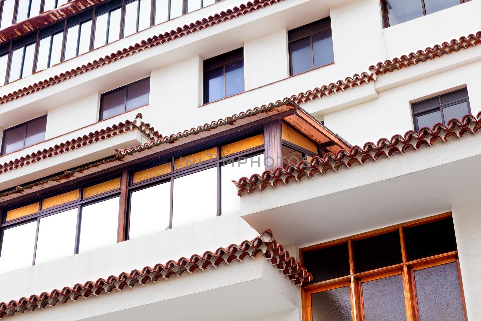 Facade building and windows close up image by carloscastilla