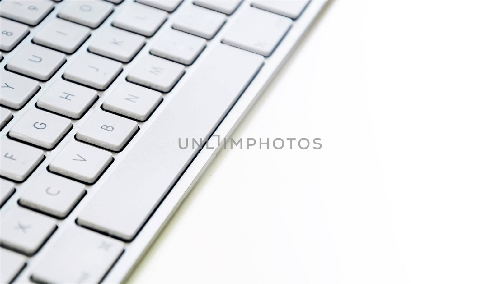 Modern computer keyboard with white keys. by rarrarorro