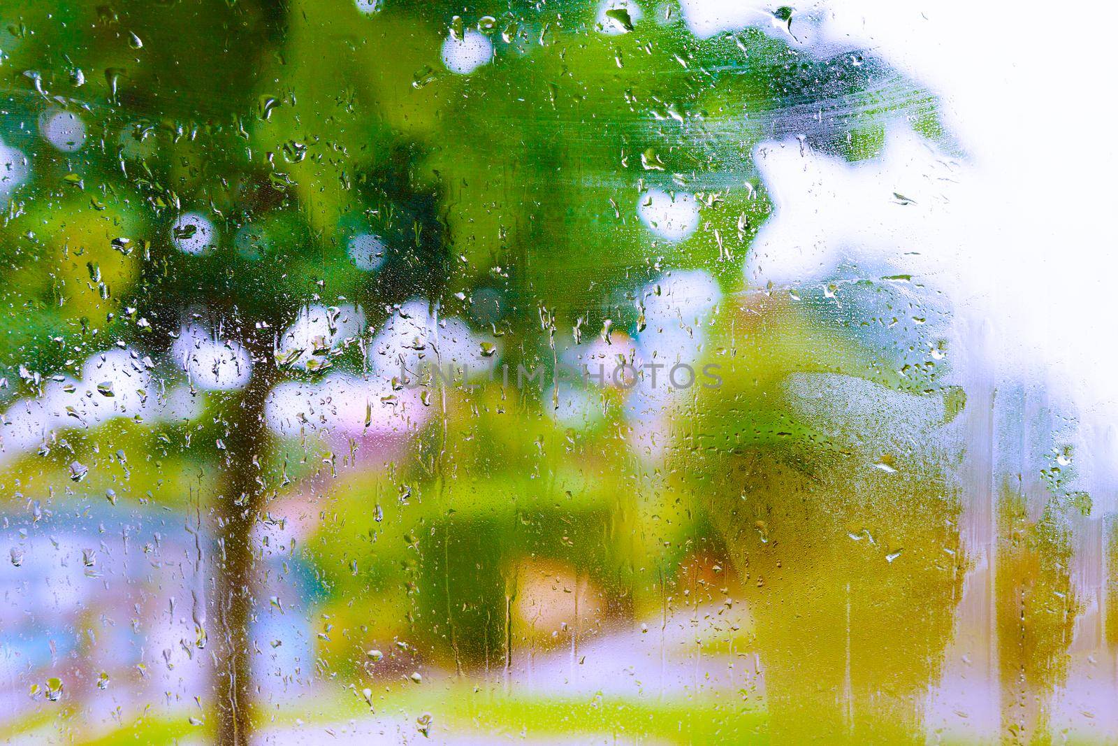 Rainy day through the wet window.Weather abstract background