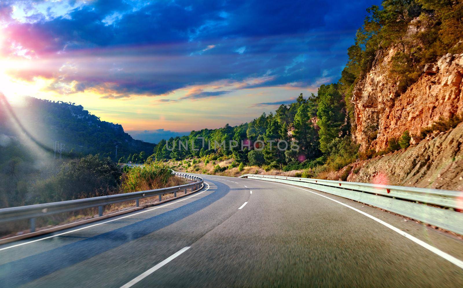 Road and travel concept.Sunset landscape and mountains