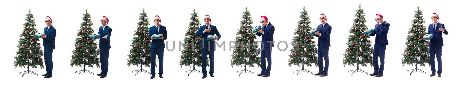 Businessman decorating christmas tree isolated on white