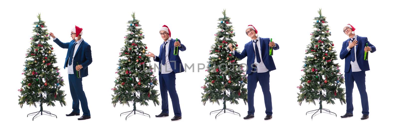 Businessman decorating christmas tree isolated on white