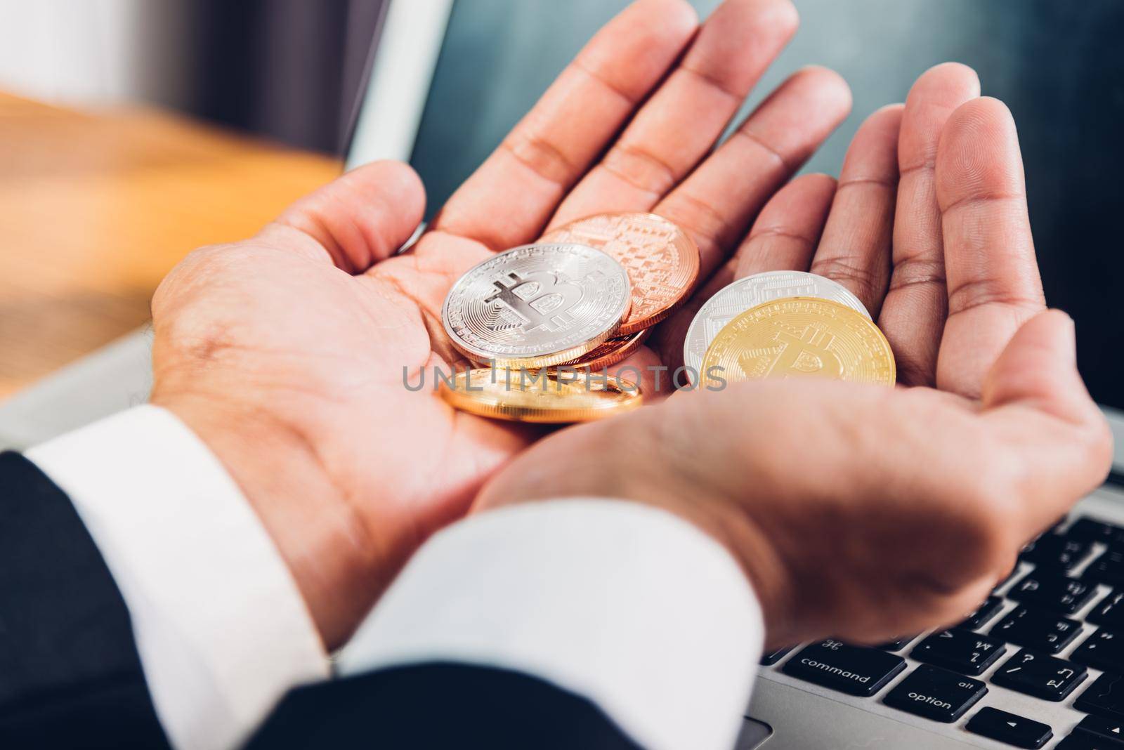 Business man holding crypto bitcoin currency money on hands,top view, finance concept