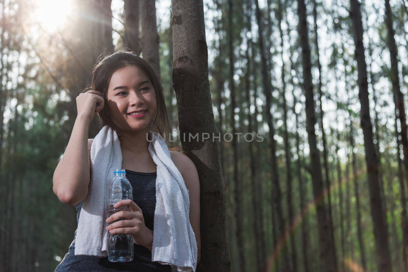 Beautiful young woman drinking water bottle after exercise fitness by Sorapop