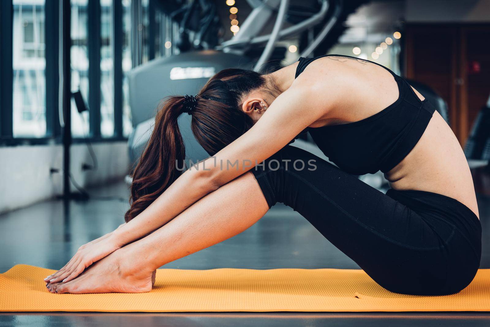 Beautiful woman yoga stretching body before exercise workout  by Sorapop