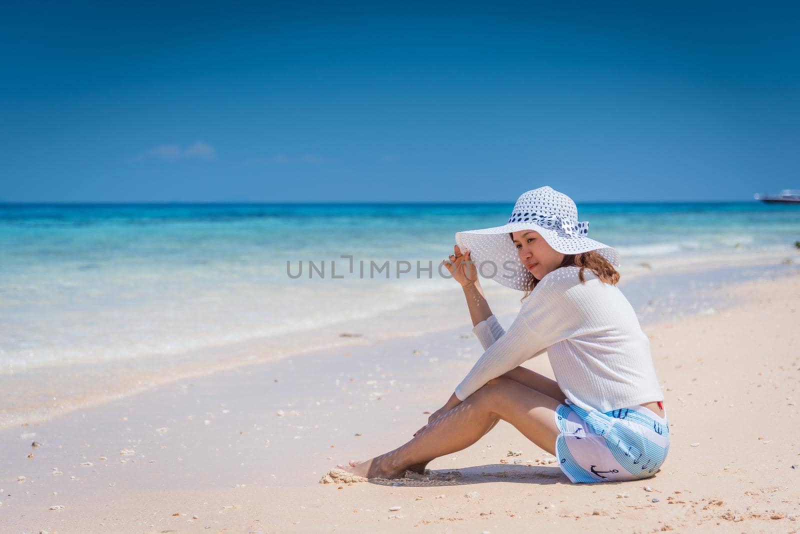 Happy young woman enjoying on beach by Sorapop