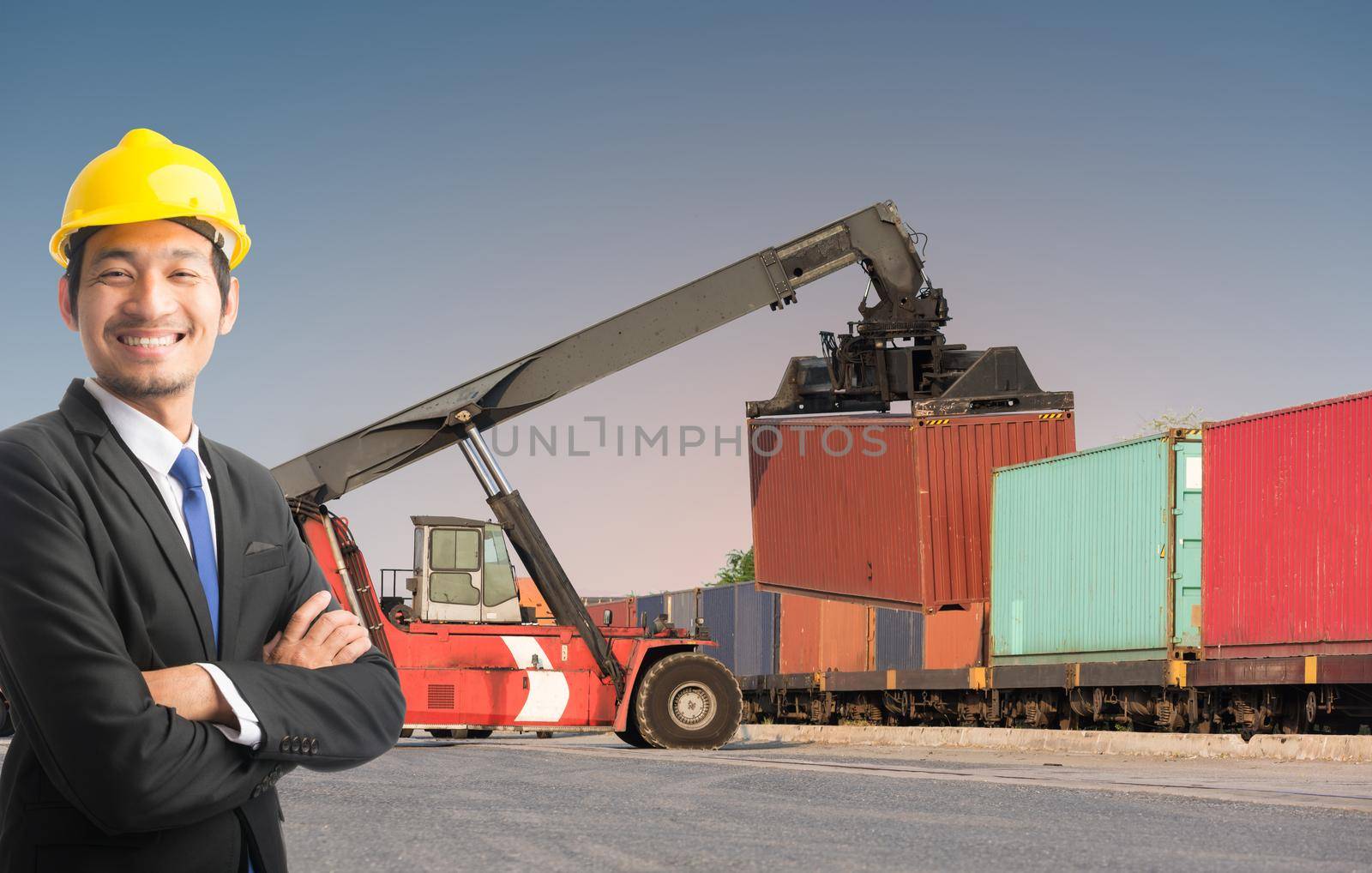 Businessman stand on front forklift loading Containers box by Sorapop