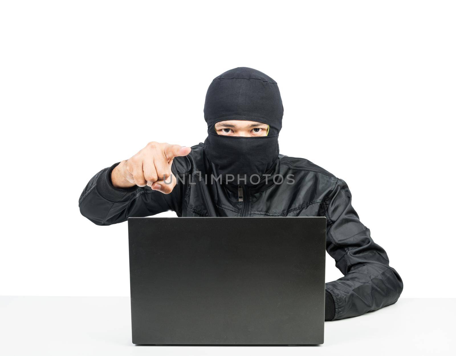 Hacker with laptop point finger by Sorapop