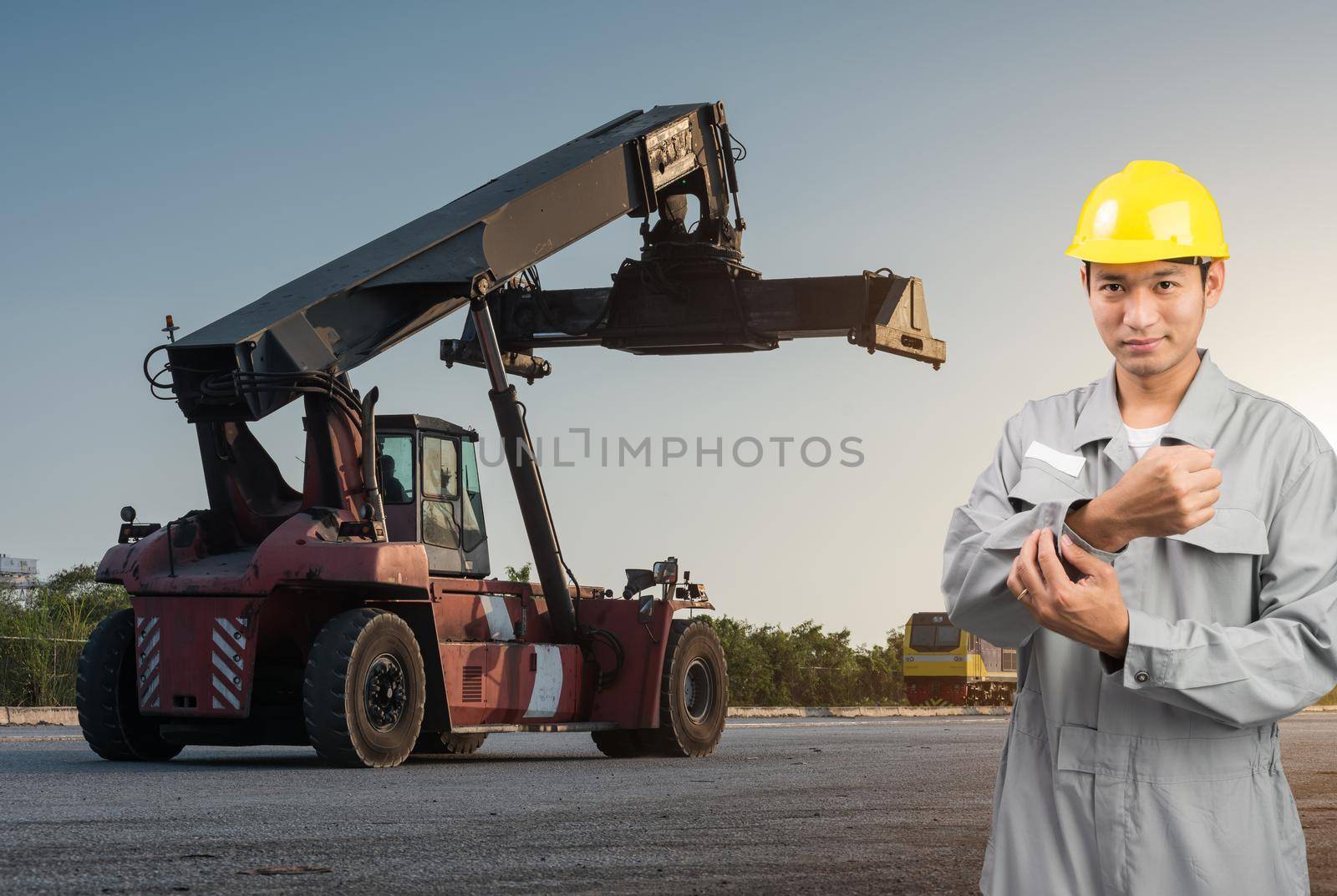 Foreman stand on front forklift loading Containers box by Sorapop