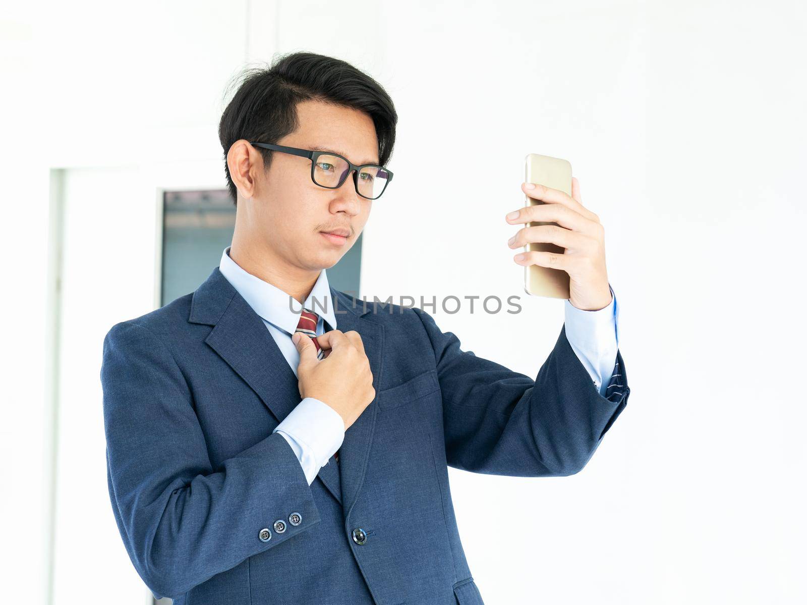 Business man holding smartphone  by stoonn