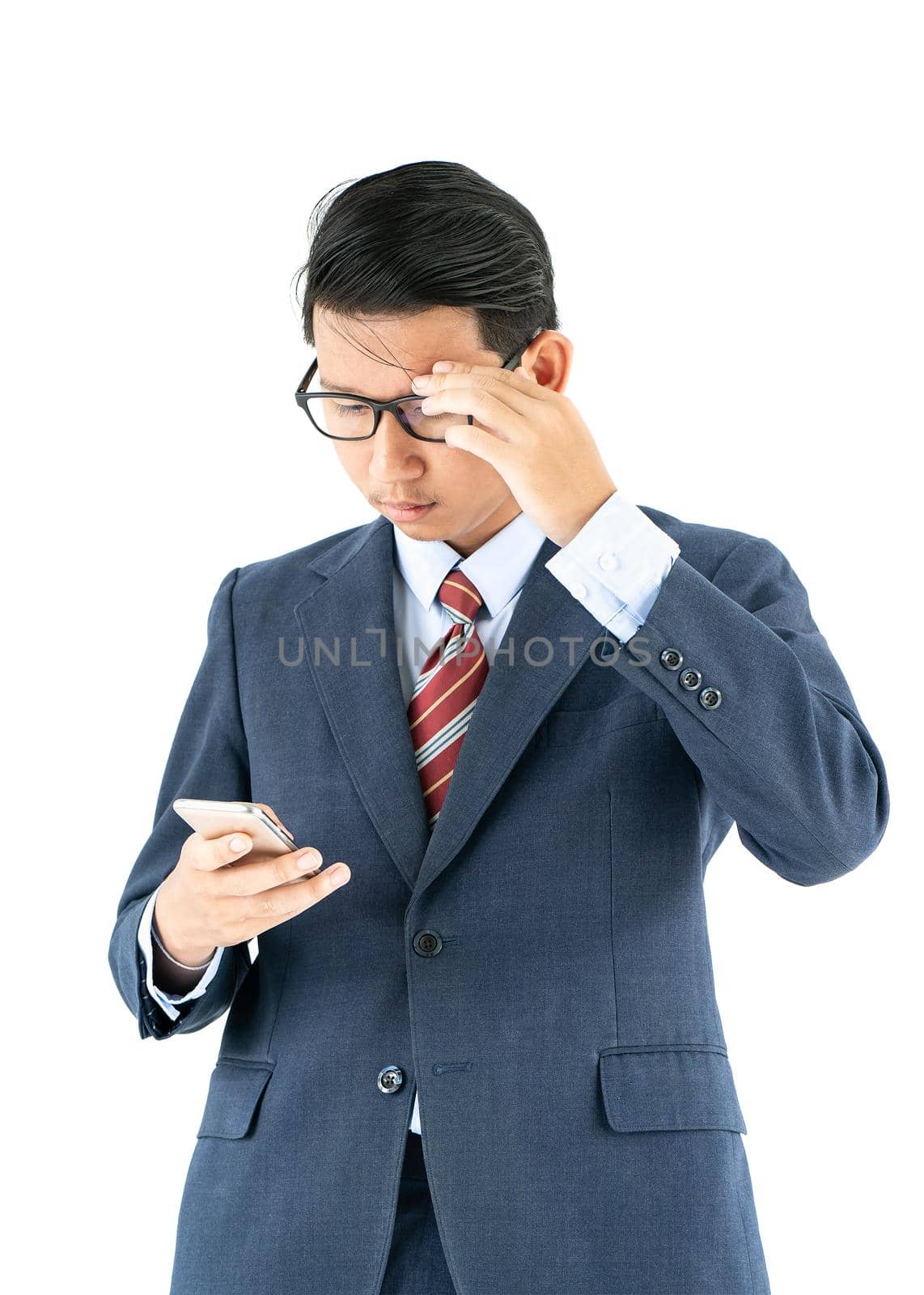Businessman in suit holding a smartphone over white background